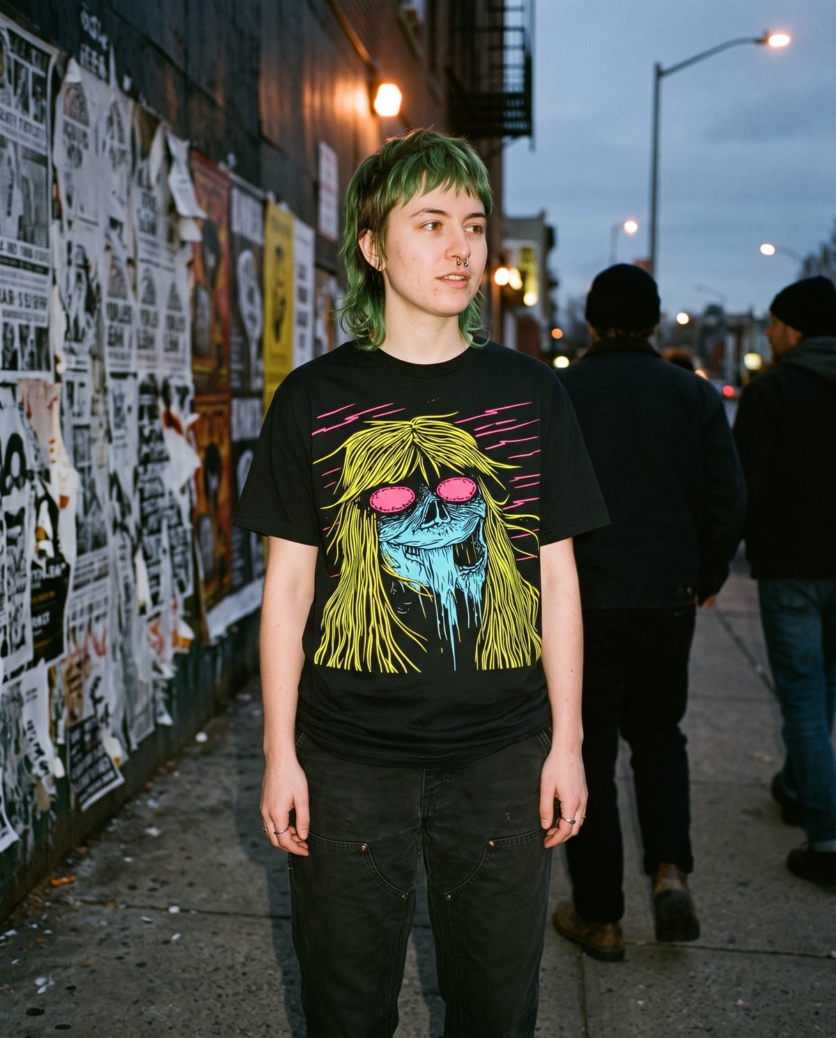 Acid Witch tee worn on a city sidewalk at dusk